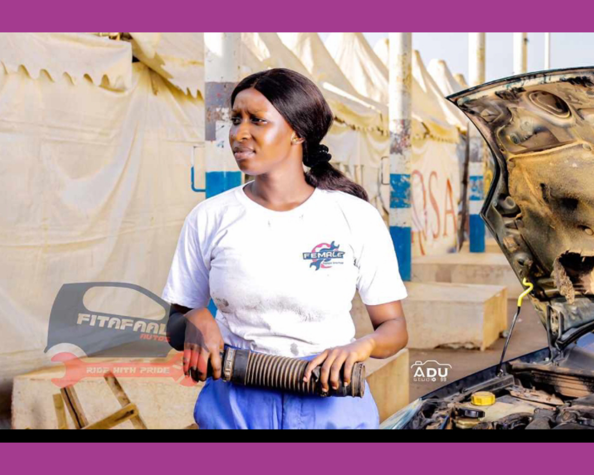 Image of Ida Faal, a female auto mechanic, working on a car in The Gambia.