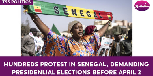 Image of protesters gathered in Senegal, holding signs and banners.