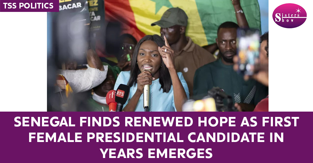 A woman speaking at a political rally, symbolizing hope and progress in Senegal